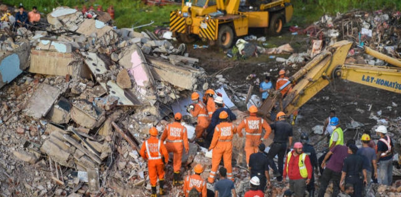 NDRF personnel sift through the rubble in search of survivors at the site where a five-storey apartment building collapsed, in Mahad in Raigad district. Credit: PTI Photo