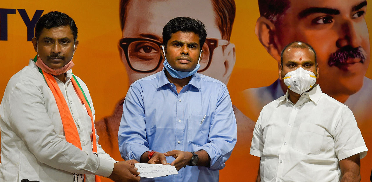 Former IPS Officer K Annamalai joins BJP in presence of BJP National General Secretary Muralidhar Rao (L) and Tamil Nadu BJP President L Murugan (R), in New Delhi. Credit: PTI