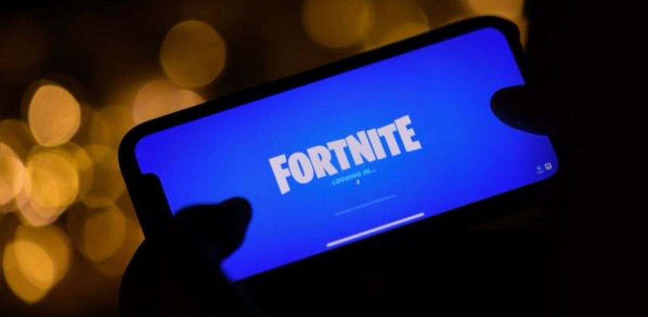A person logging into Epic Games' Fortnite on their smartphone. Credit: AFP