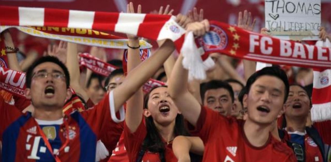 Bayern Munich supporters cheering before a friendly football match between Bayern Munich and Inter Milan in Shanghai. Credit: AFP