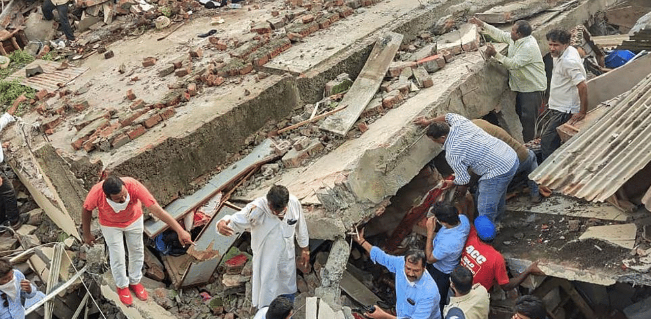 Rescue operations underway after a three-storey residential building collapsed, in Dewas. credit: PTI