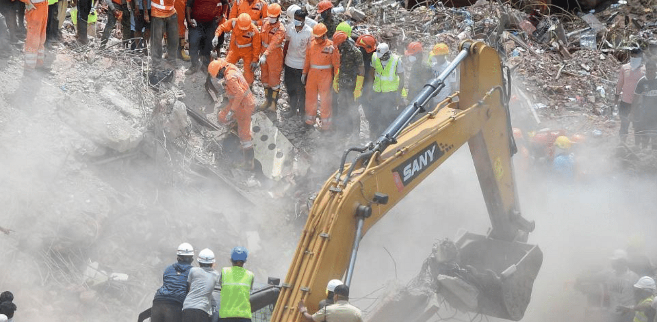 Rescue personnel sift through the rubble in search of survivors at the site where a five-storey apartment building collapsed, at Mahad in Raigad district. Credit: PTI
