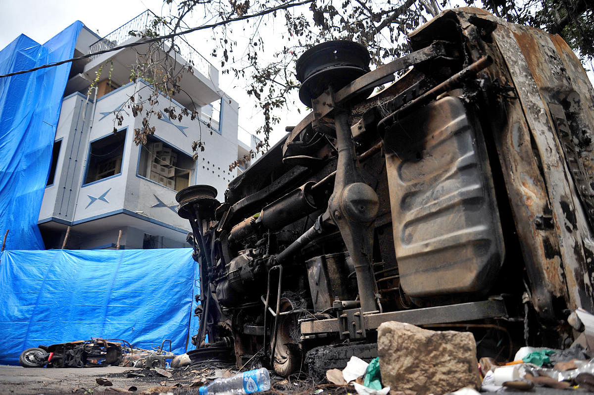 Vehicles in front of the residence of MLA R Akhanda Srinivasa Murthy, whose house was burnt during the riots on August 11. DH FILE/Pushkar V