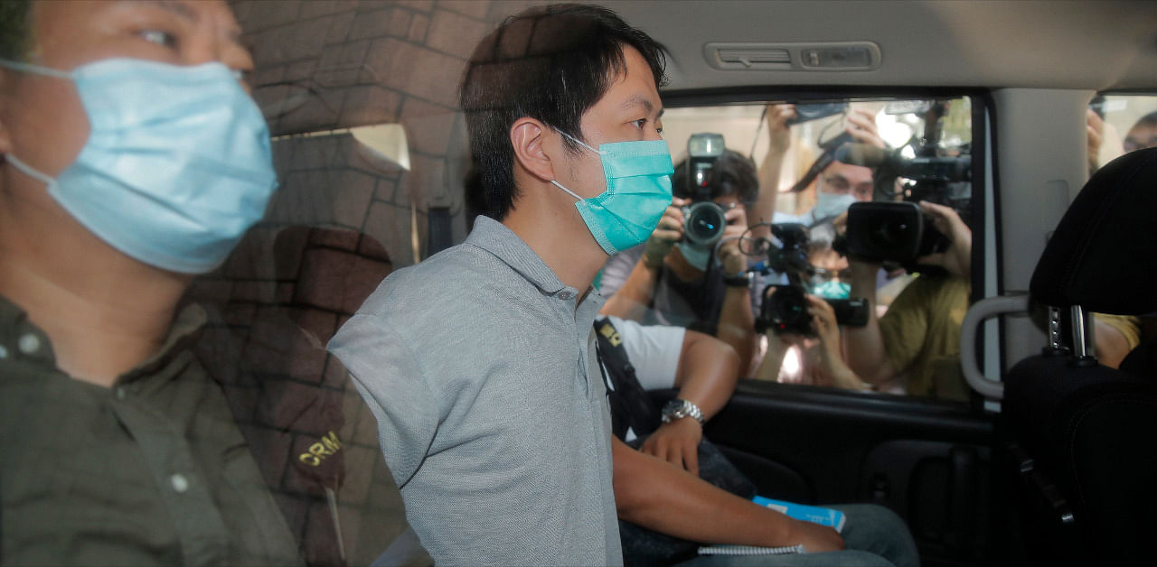 Pro-democracy legislator Ted Hui, center, is arrested by police officers in Hong Kong. Credit: AP Photo