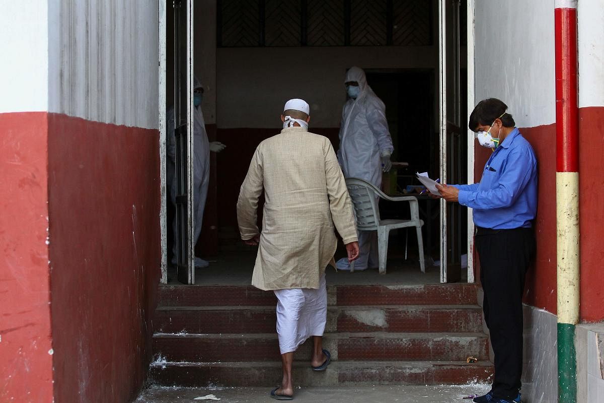 A man, who attended a religious event at Nizamuddin Markaz in New Delhi where many have tested COVID-19 coranavirus positive, arrives to be tested in Allahabad on April 1, 2020. (Photo by SANJAY KANOJIA / AFP)
