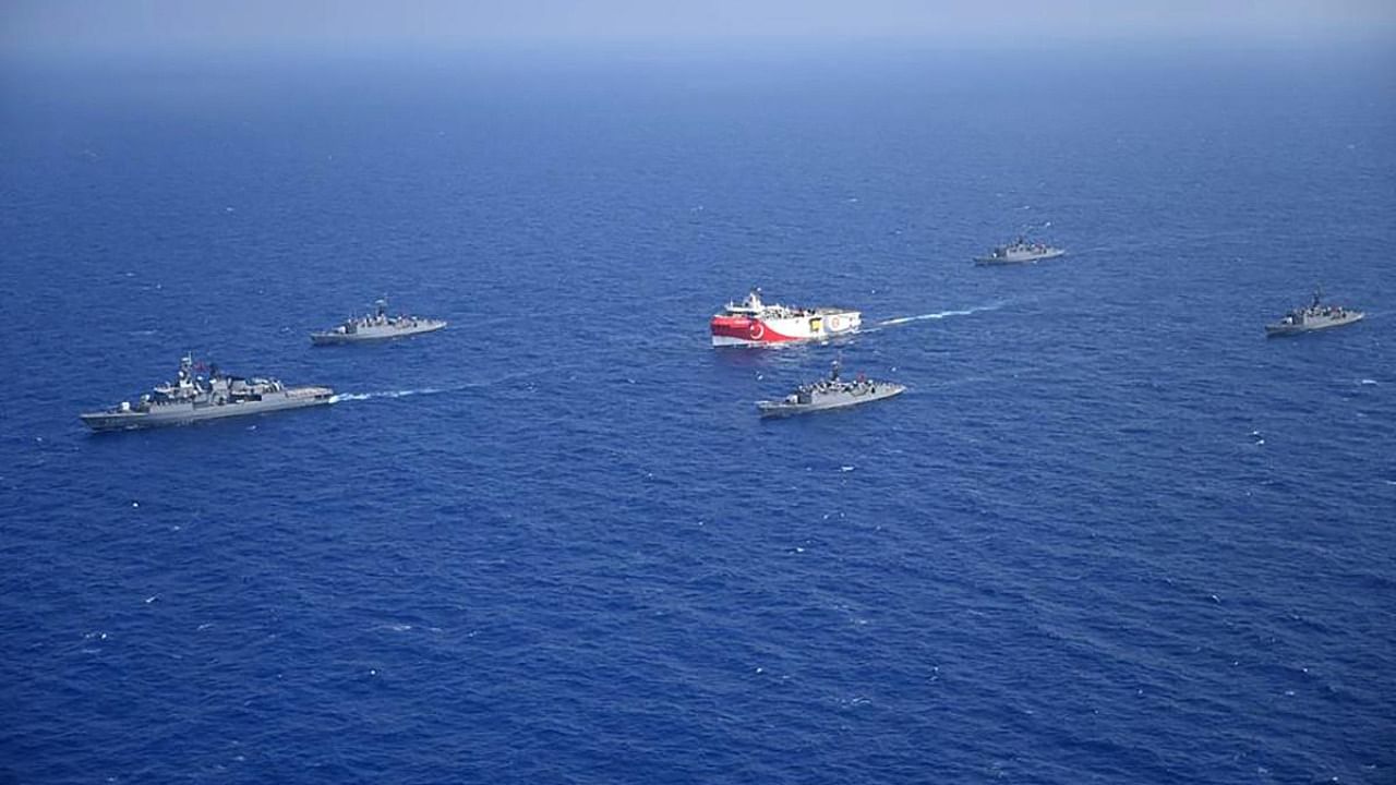 This file handout photograph released by the Turkish Defence Ministry on August 12, 2020, shows Turkish seismic research vessel 'Oruc Reis' (C) as it is escorted by Turkish Naval ships in the Mediterranean Sea, off Antalya. Credit: AFP/Turkish Defence Ministry
