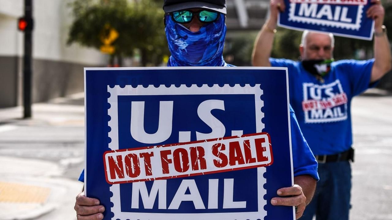 People attend a rally in support of the US postal service in Miami, Florida. Credit: AFP