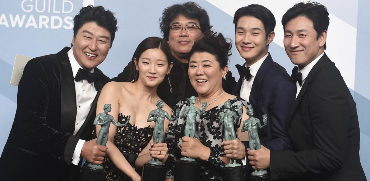 Kang-Ho Song (L) with the cast and director of Parasite. Credits: AP