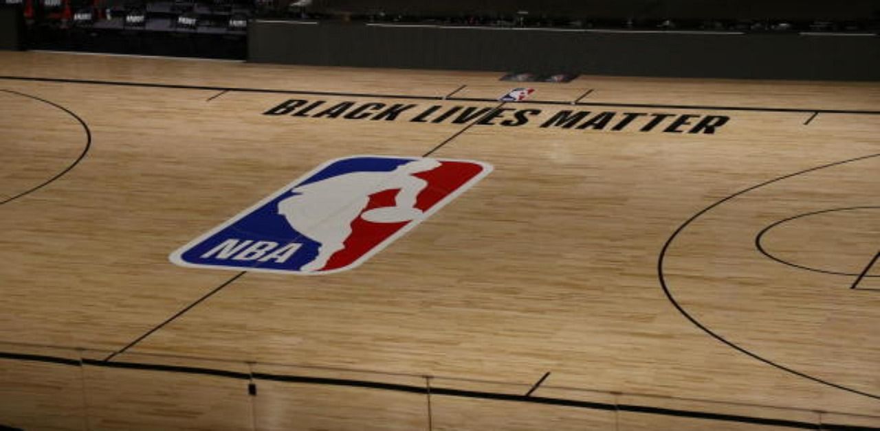 The Black Lives Matter logo is seen on an empty court as all NBA playoff games. Credit: AFP