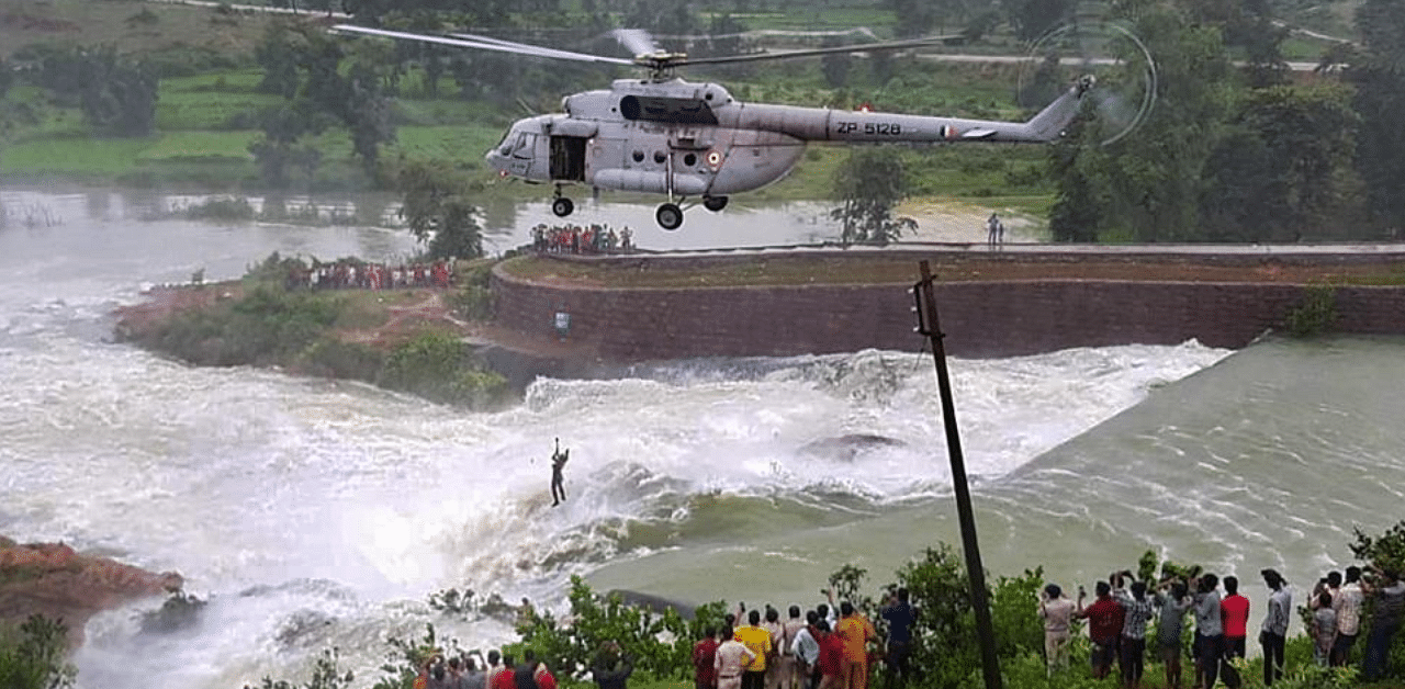 Indian Air Force (IAF) conduct a rescue operation of a man holding on to a tree in a overflowing dam in Chhattisgarh's Bilaspur. Credit: PTI