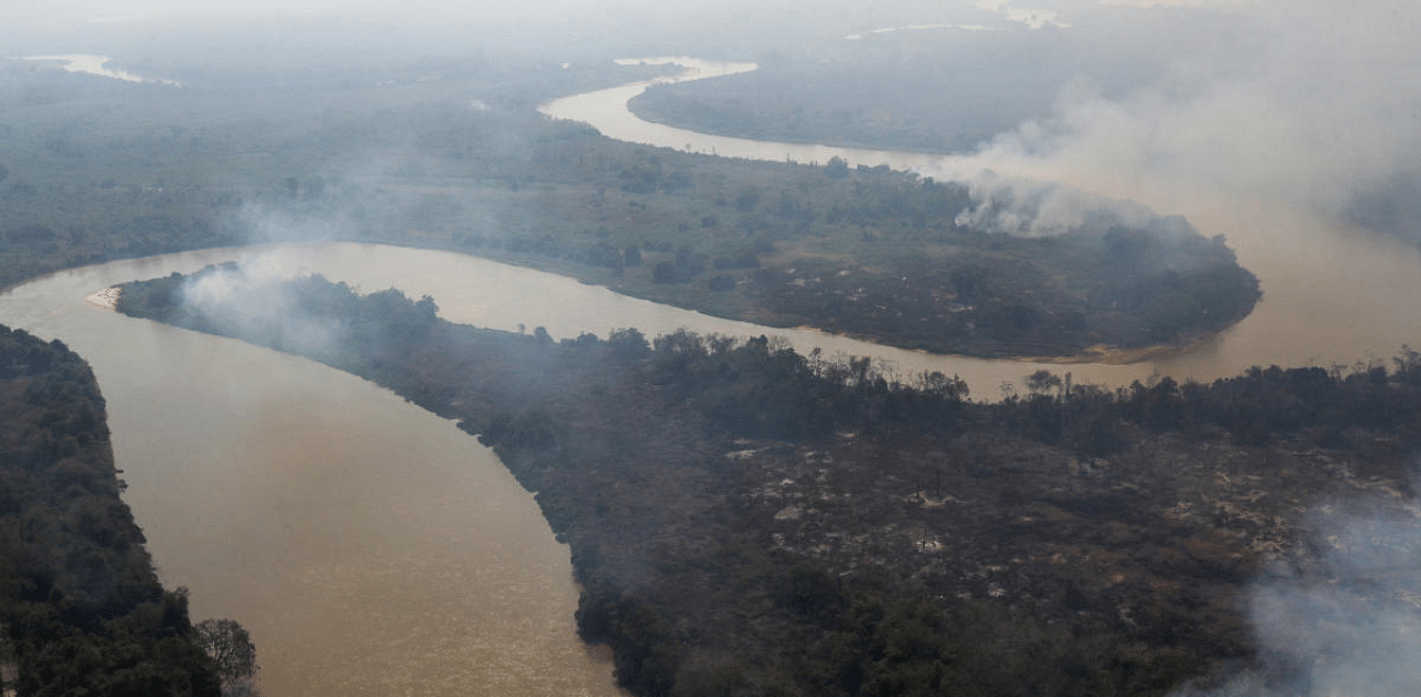 Smoke from a fire is seen near Cuiaba River at Pantanal, in Pocone, Mato Grosso state, Brazil. Credit: Reuters Photo