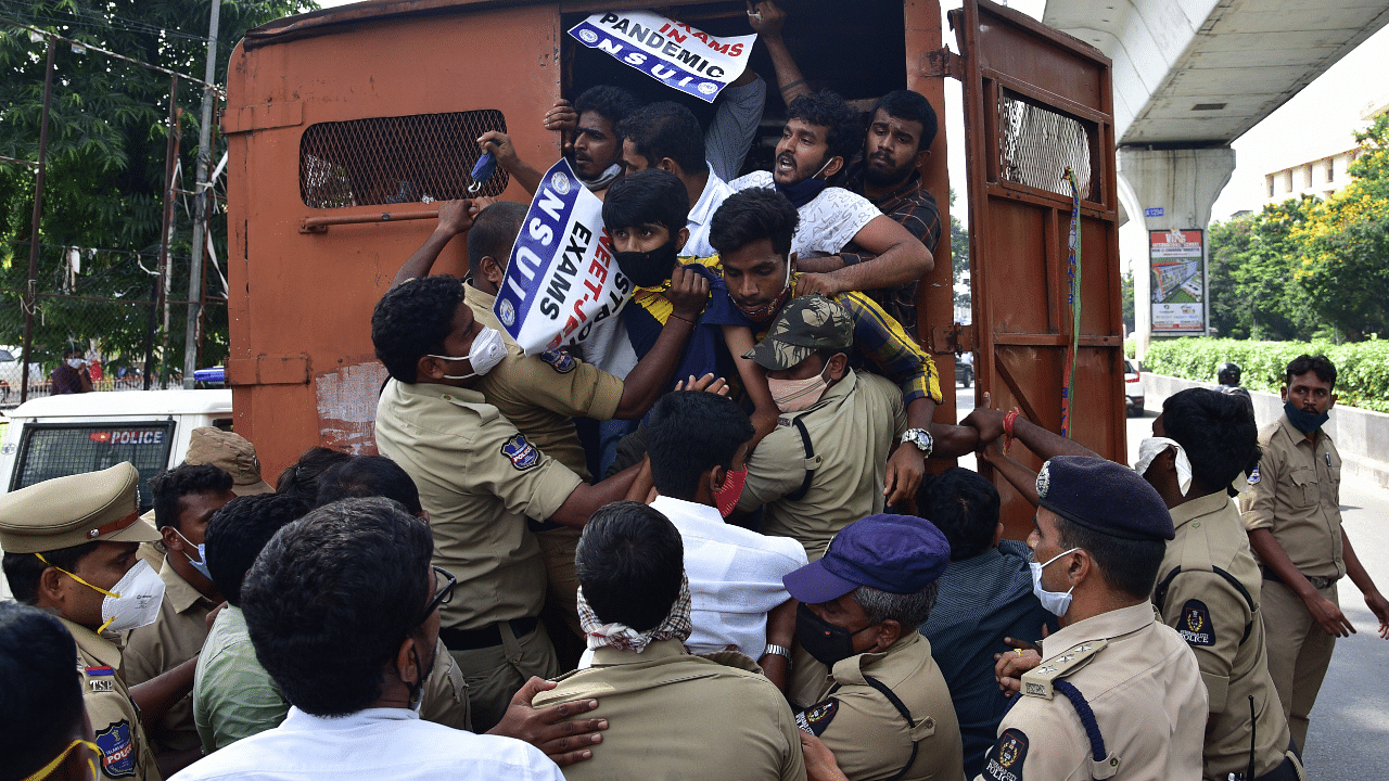 Police detain NSUI supporters, who were staging 'Chalo Raj Bhavan' protest against holding of NEET and JEE examination. Credits: PTI Photo