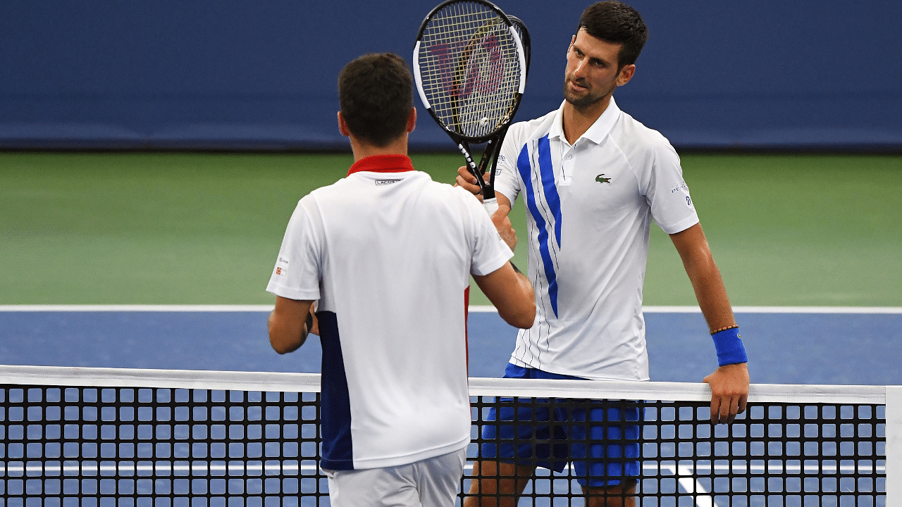 Novak Djokovic (SRB) greets Roberto Bautista Agut (ESP) at the net after their match in the Western & Southern Open at the USTA Billie Jean King National Tennis Center. Credits: USA Today