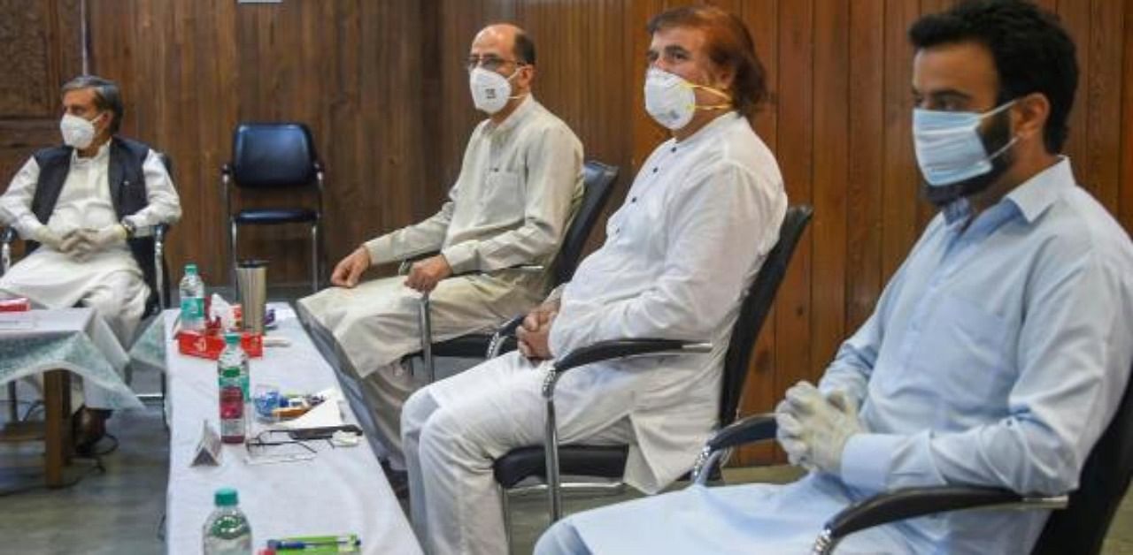 ammu and Kashmir National Conference members attend the party's first-ever meeting after abrogation of article 370 and 35A, at the party headquarter Nawa-e-Subha, in Srinagar. Credit: PTI Photo