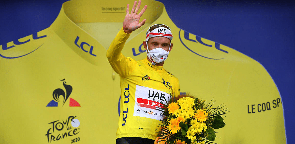 UAE Team Emirates rider Alexander Kristoff of Norway, wearing the overall leader's yellow jersey, celebrates on the podium. Credit: Reuters