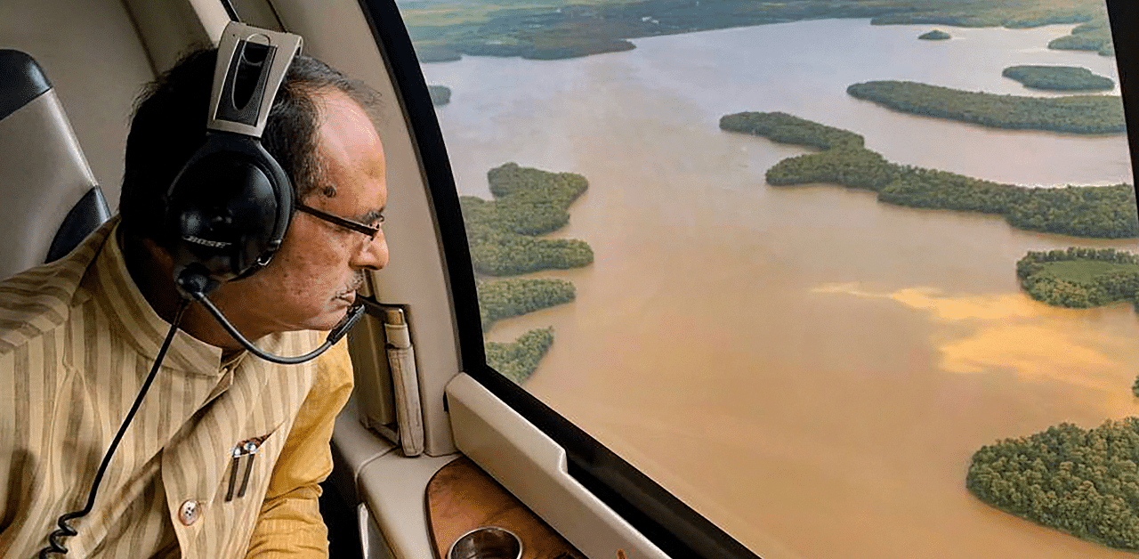 Madhya Pradesh Chief Minister Shivraj Singh Chouhan conducts an aerial survey of flood-affected areas. Credit: PTI Photo
