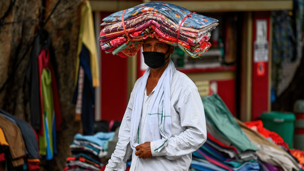 A cloth vendor wearing a facemask as a preventive measure against the spread of the Covid-19. Credits: AFP Photo