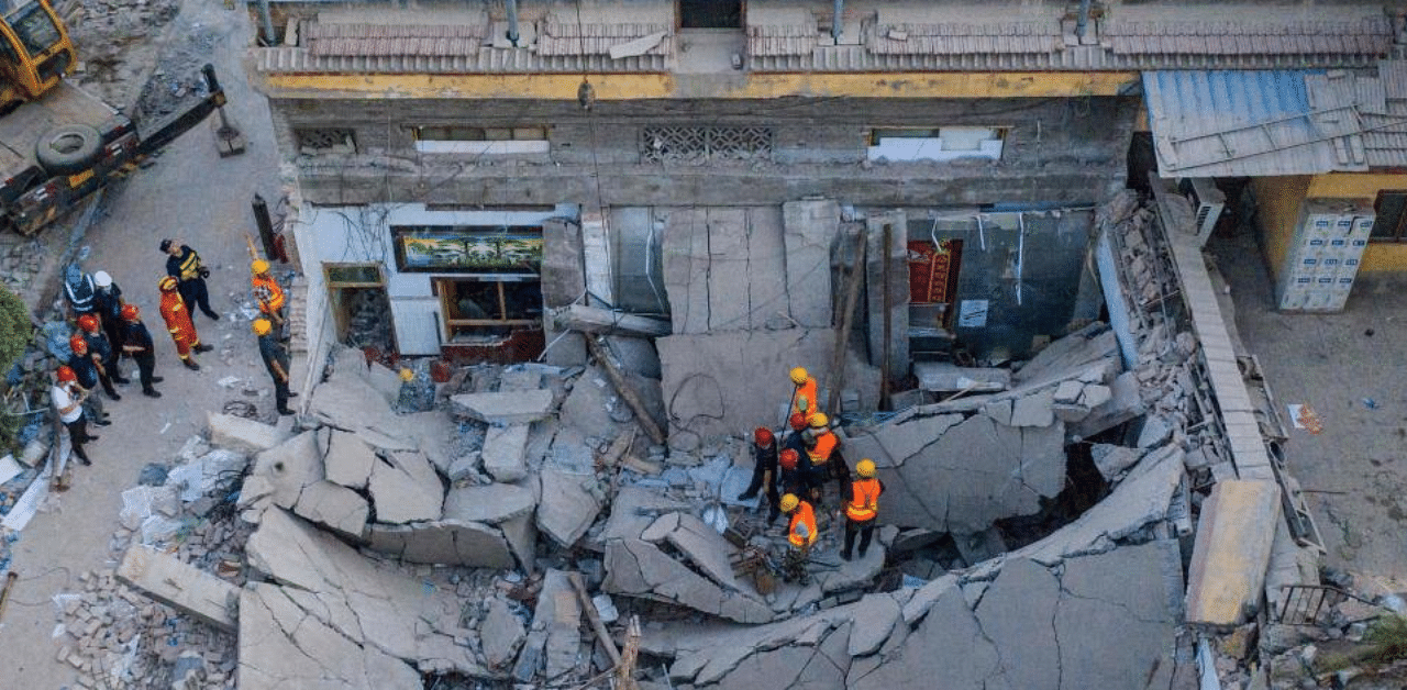 The  rescuers searching through the rubble of a collapsed restaurant in Linfen, in China's northern Shanxi province. Credit: AFP