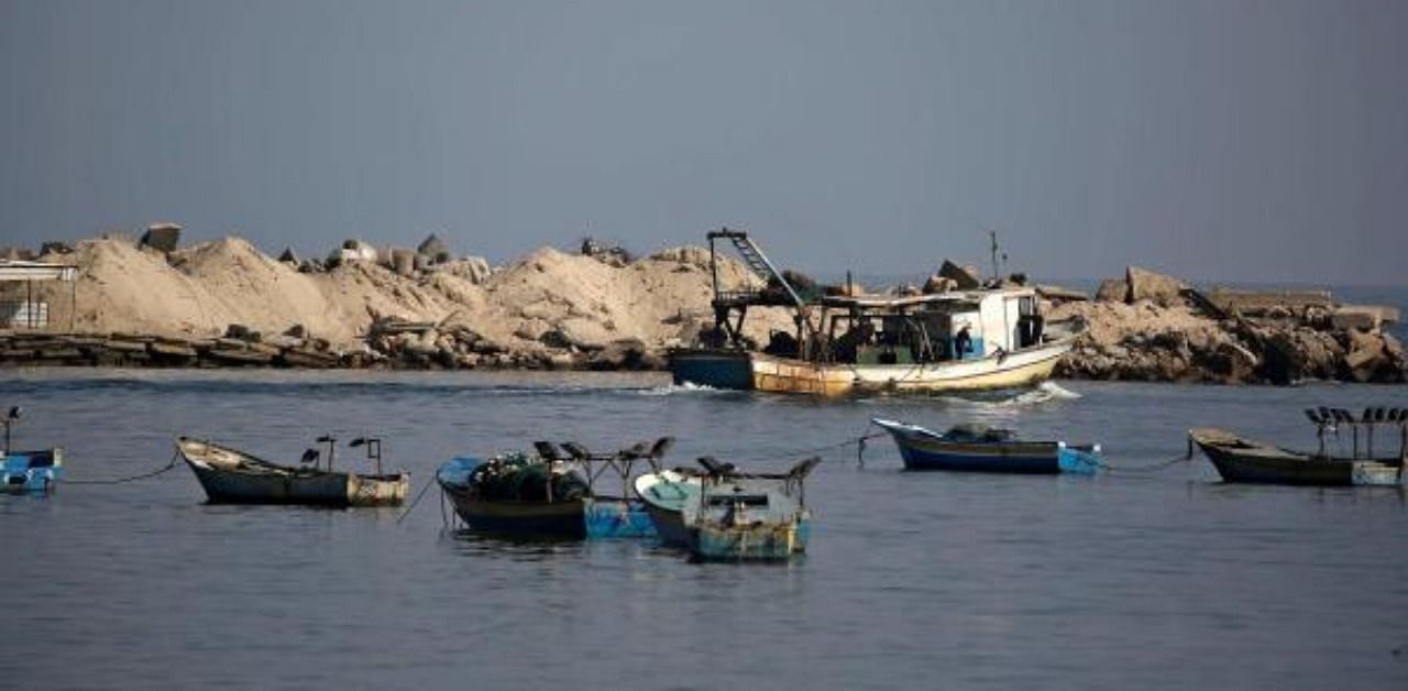 Palestinian fishermen ride their boats at the seaport of Gaza City. AFP Photo