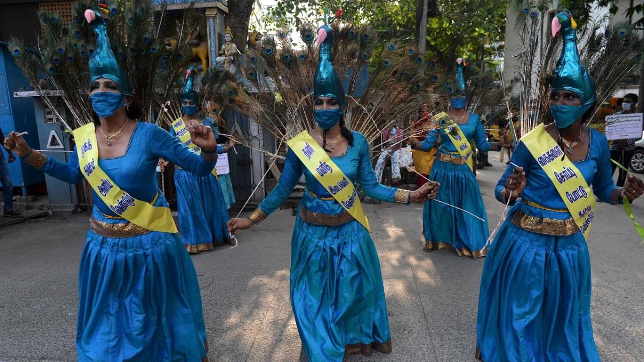 Members of the transgender community perform a peacock dance during an awareness raising campaign against the spread of the Covid-19 coronavirus. Credit: AFP