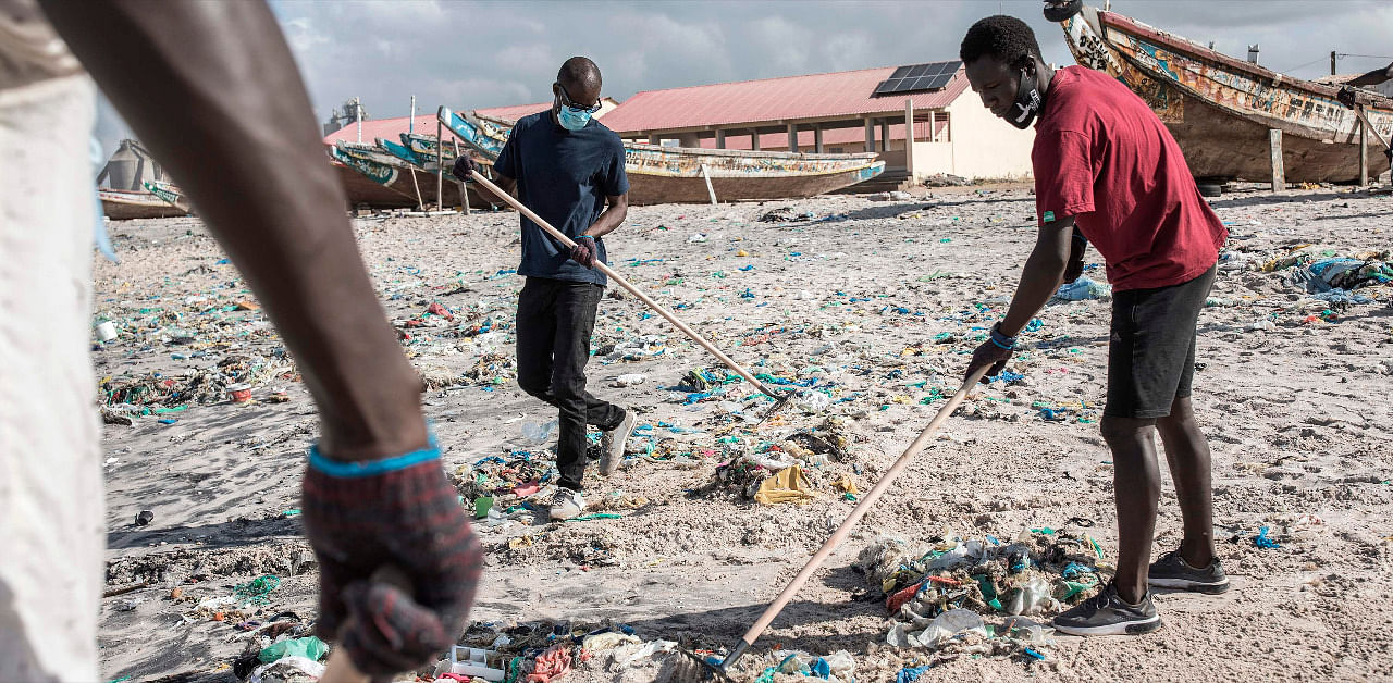 Senegalese youth clean the beach of plastic after organising a beach cleaning day along the coastline in Bargny. Credit: AFP Photo