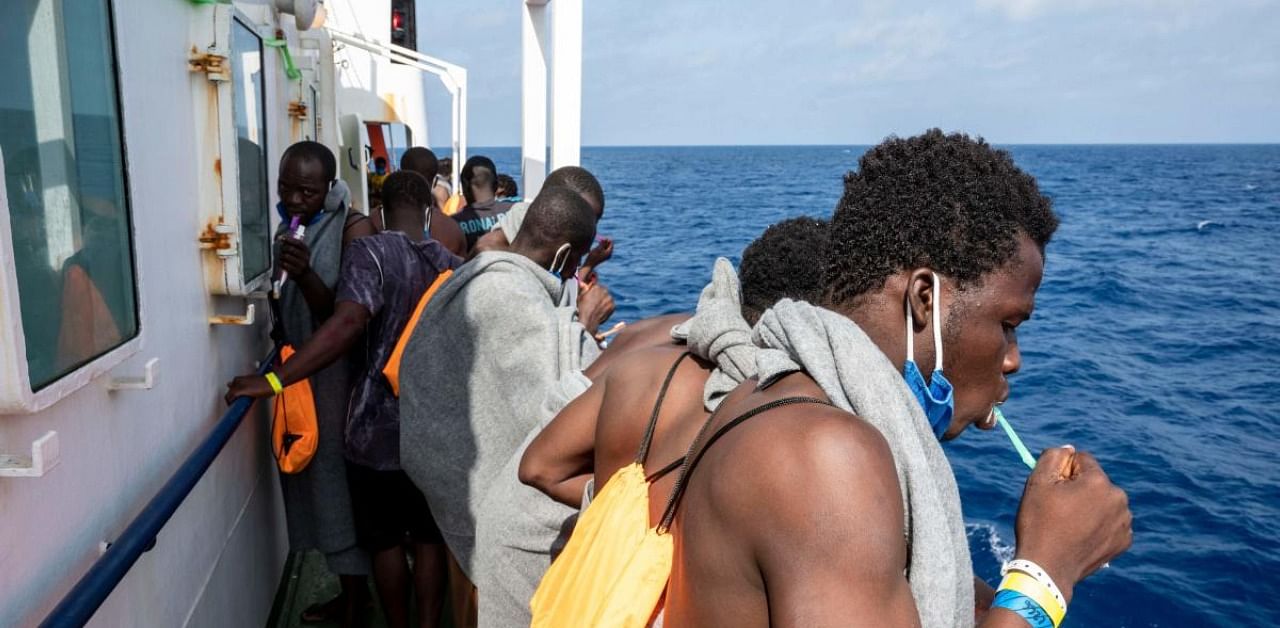 Migrants brush their teeth onboard the Sea-Watch 4 civil sea rescue ship, that is waiting for permission to run into a port, on sea between Malta and Italy. Credits: AFP