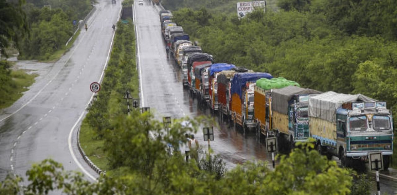 Truck stranded at J&K National Highway as it remains closed due to multiple landslides triggered by rains, in Jammu. Credit: PTI Photo