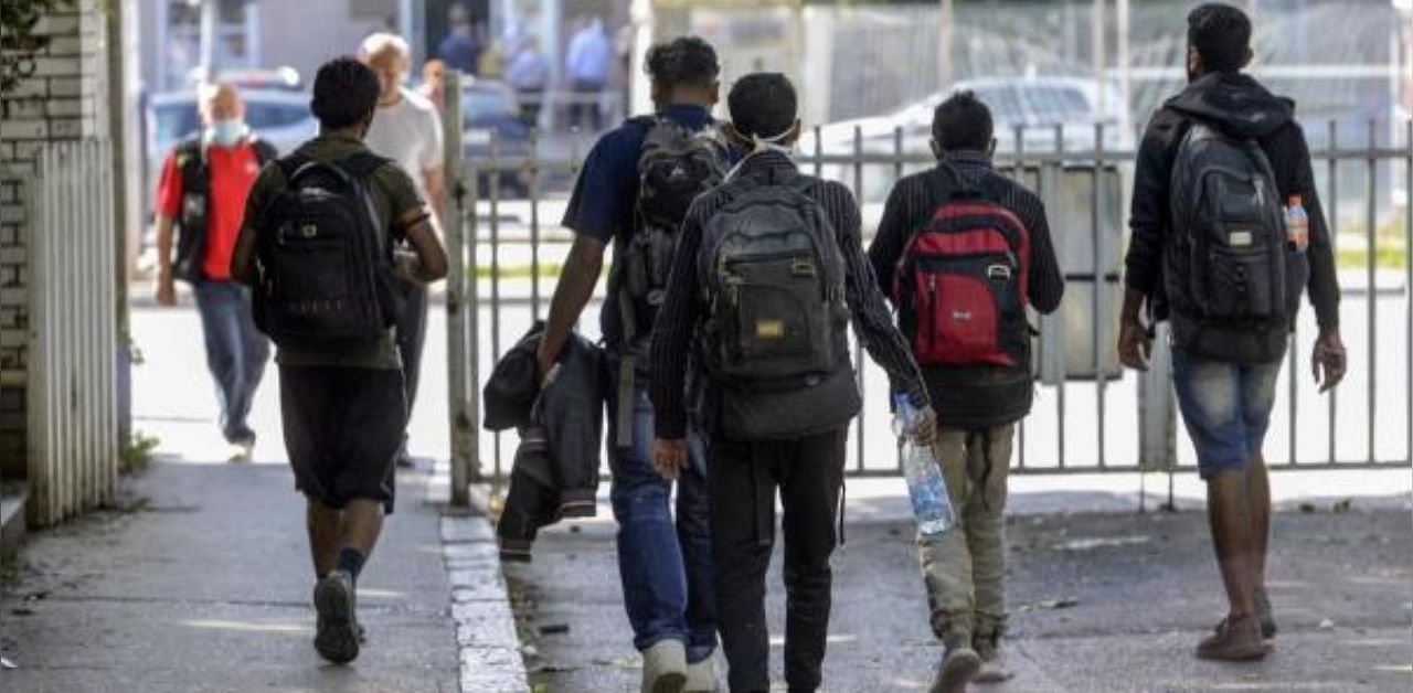 A group of migrants walk at the bus station on August 27, 2020 in Sarajevo. Credit: AFP Photo