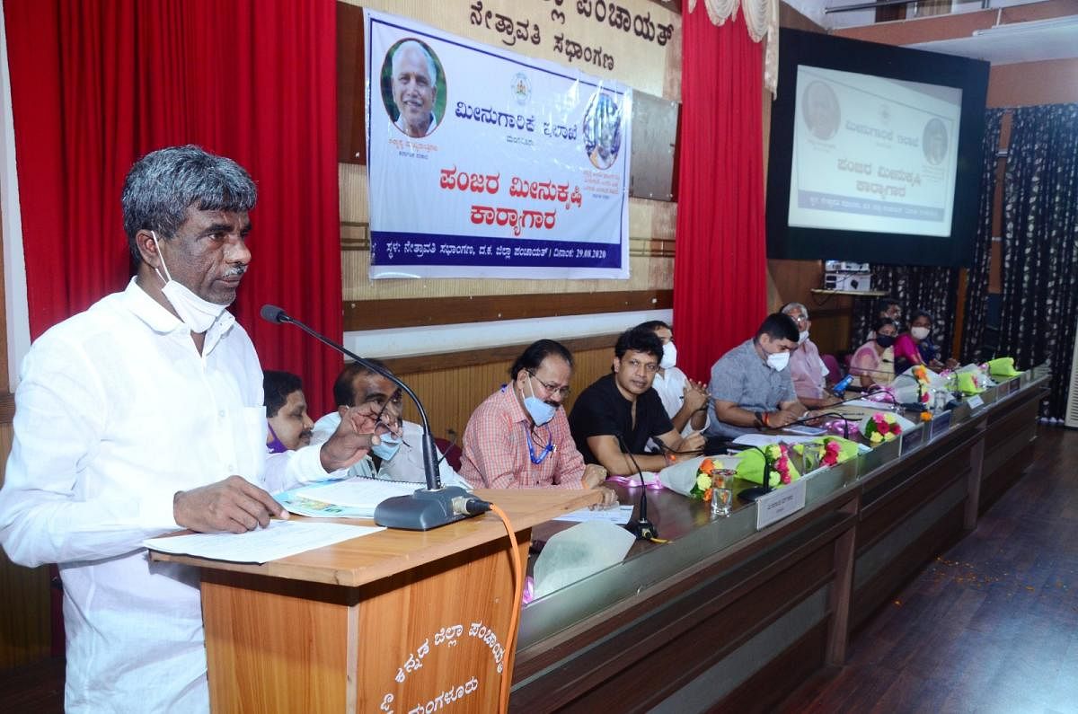 Minister for Fisheries, Ports and Inland Water Transport Kota Srinivas Poojary speaks during a training programme on cage fish farming at ZP Hall in Mangaluru.