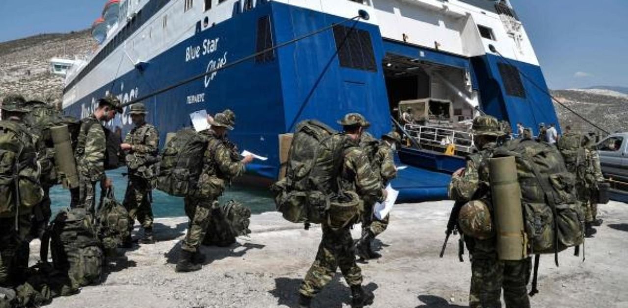 Greek soldiers prepare to board a ferry at the port of the tiny Greek island of Kastellorizo. Credit: AFP