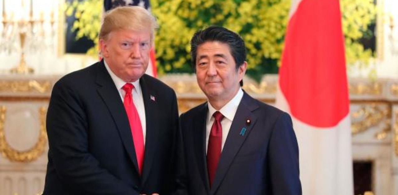 US President Donald Trump (L) and Japanese Prime Minister Shinzo Abe shake hands. Credit: AFP