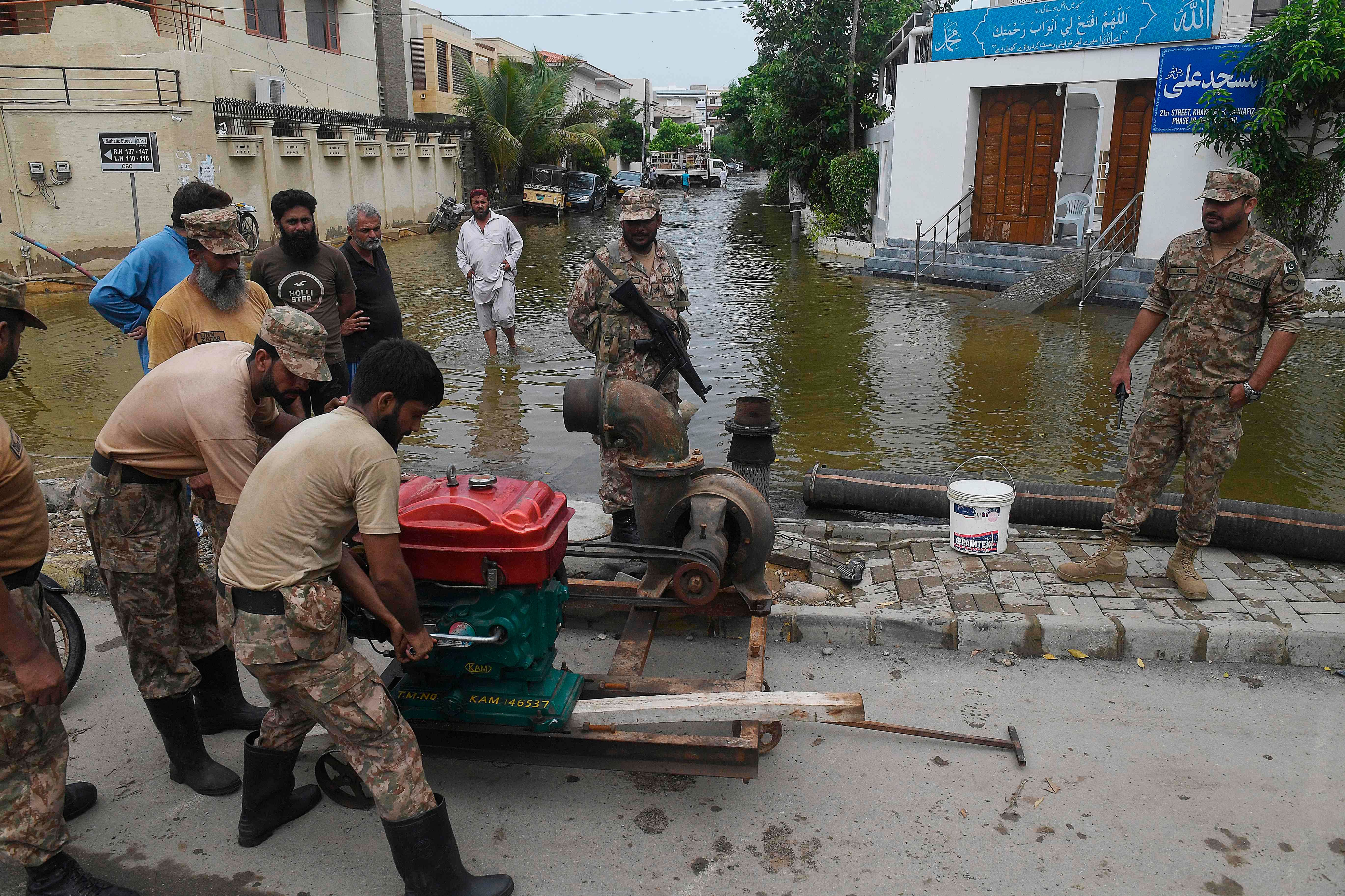 Troops install a water pump to remove water from a flooded residential area following heavy monsoon rains triggered floods in Pakistan's port city of Karachi on August 31, 2020. - Karachi residents began cleaning ruined homes and businesses on August 31 after catastrophic flooding sent rivers of filthy water cascading through Pakistan's largest city, while deadly monsoon weather continued to lash communities across South Asia. Credit: AFP