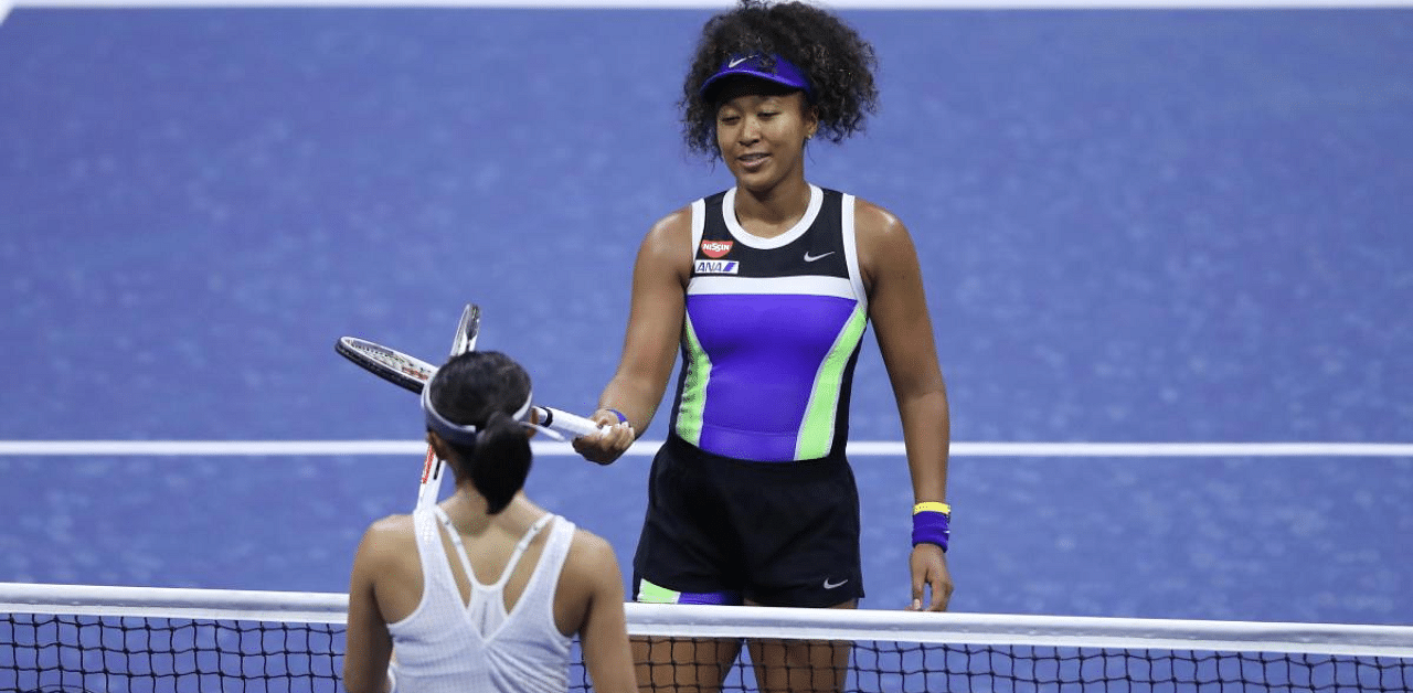 Naomi Osaka of Japan taps rackets after winning during her Womens Singles first round match against Misaki Doi of Japan on Day One of the 2020 US Open. Credit: AFP Photo