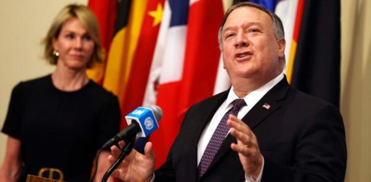 US Secretary of State Mike Pompeo is flanked by US Ambassador to the United Nations Kelly Craft as he speaks to reporters following a meeting with members of the UN Security Council about Iran's alleged non-compliance with a nuclear deal and calling for the restoration of sanctions against Iran at United Nations hradquarters in New York. Credit: AFP Photo