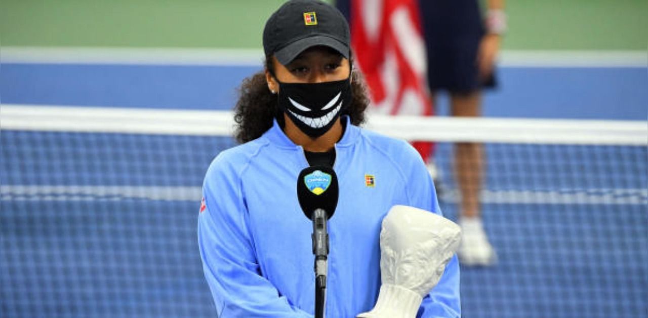 Naomi Osaka (JPN) with her 2nd place trophy on the court during the awards ceremony for singles champion Victoria Azarenka (BLR) in the Western & Southern Open at the USTA Billie Jean King National Tennis Center. Credit: USA Today Sports