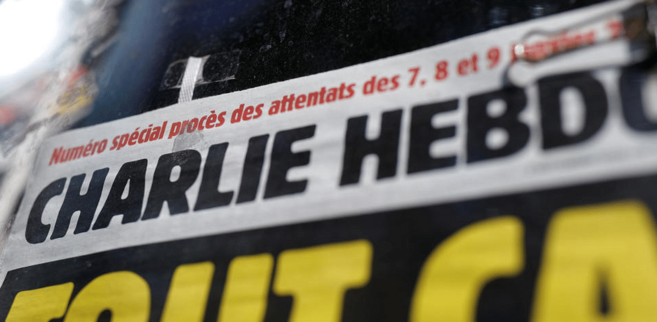 The front page of French satirical magazine Charlie Hebdo is seen at a newspapers kiosk in Paris on the opening day of the trial of the January 2015 Paris attacks against Charlie Hebdo satirical weekly, a policewoman in Montrouge and the Hyper Cacher kosher supermarket, at Paris courthouse, France, Steptember 2, 2020. Credit: Reuters Photo