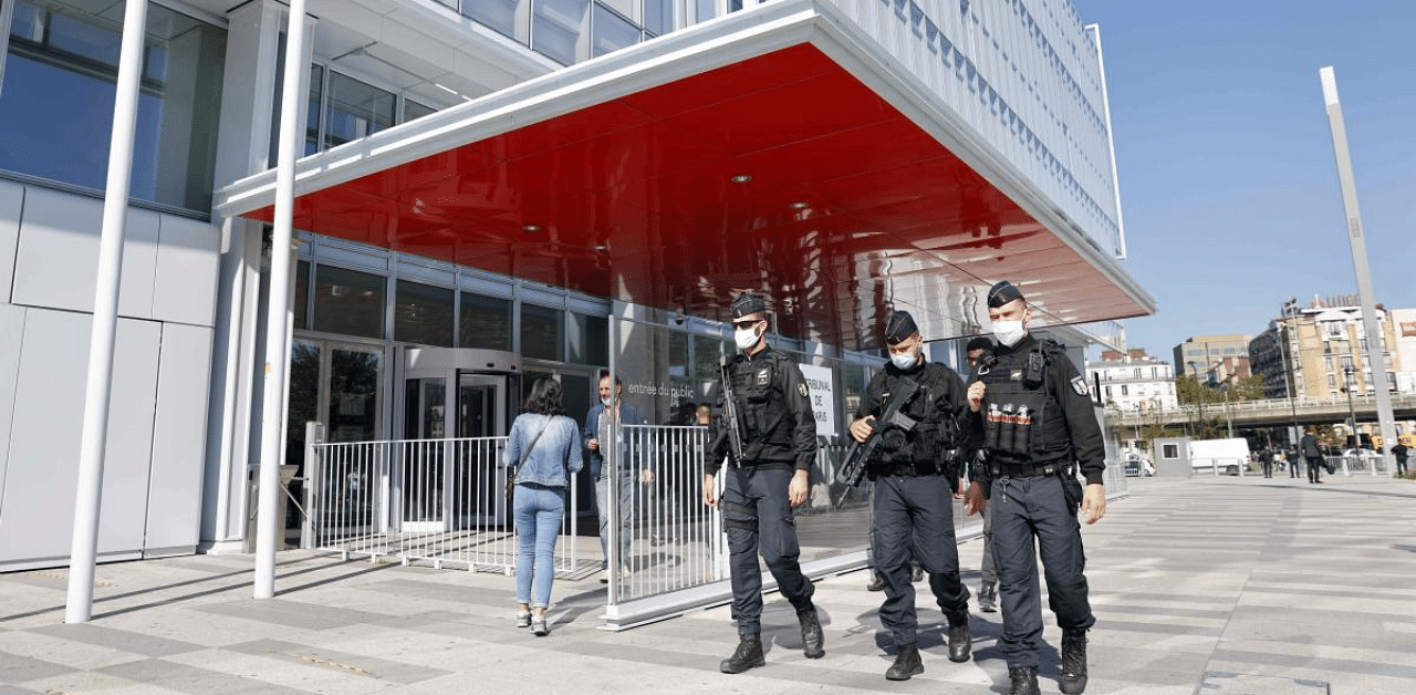 Police officers patrol outside Paris' courthouse on the opening day of the trial of 14 suspected accomplices in Charlie Hebdo jihadist killings. Credit: AFP Photo