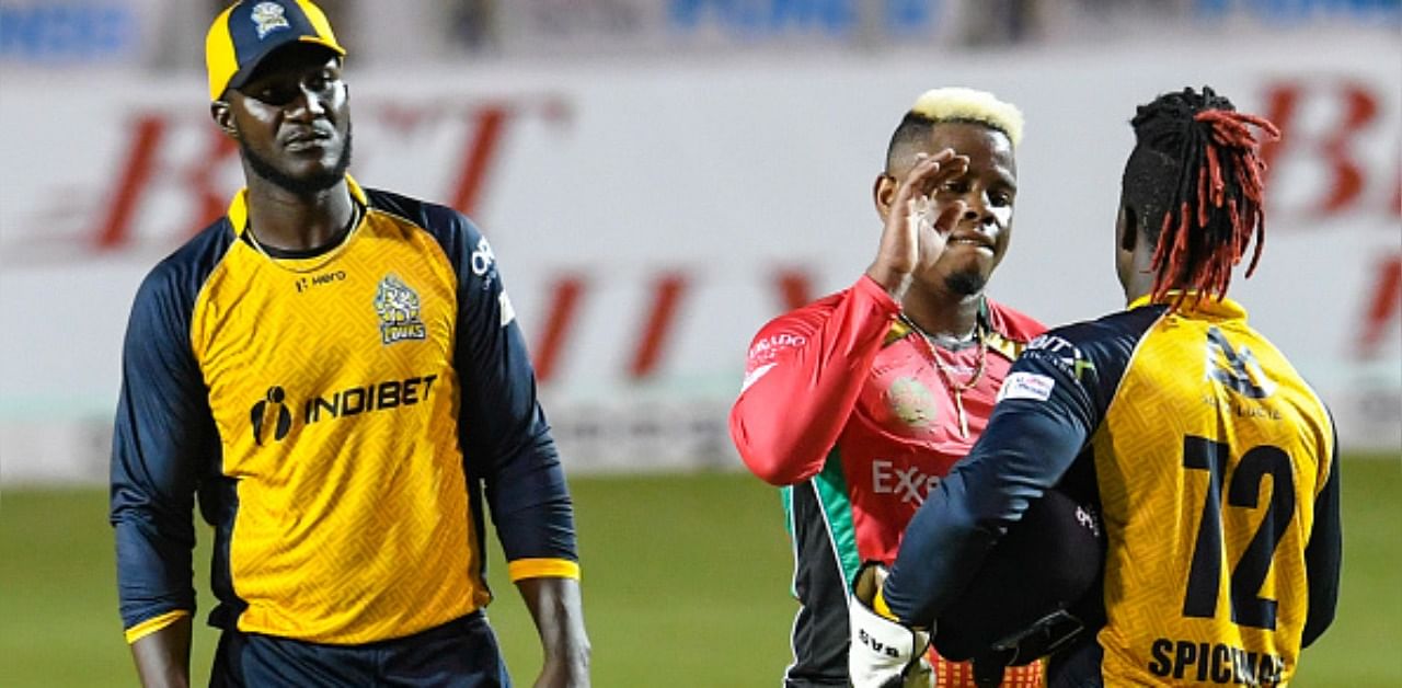 Darren Sammy (L) watches as Andre Fletcher (R) of St Lucia Zouks congratulate Shimron Hetmyer (C) of Guyana Amazon Warriors for winning the Hero Caribbean Premier League match 24. Credit: Getty Images