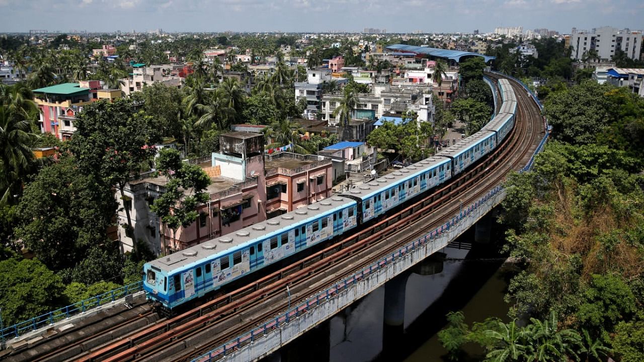 A metro train carrying staff members moves through a residential area ahead of the restart of its operation, amidst the spread of the coronavirus disease. Credit: PTI