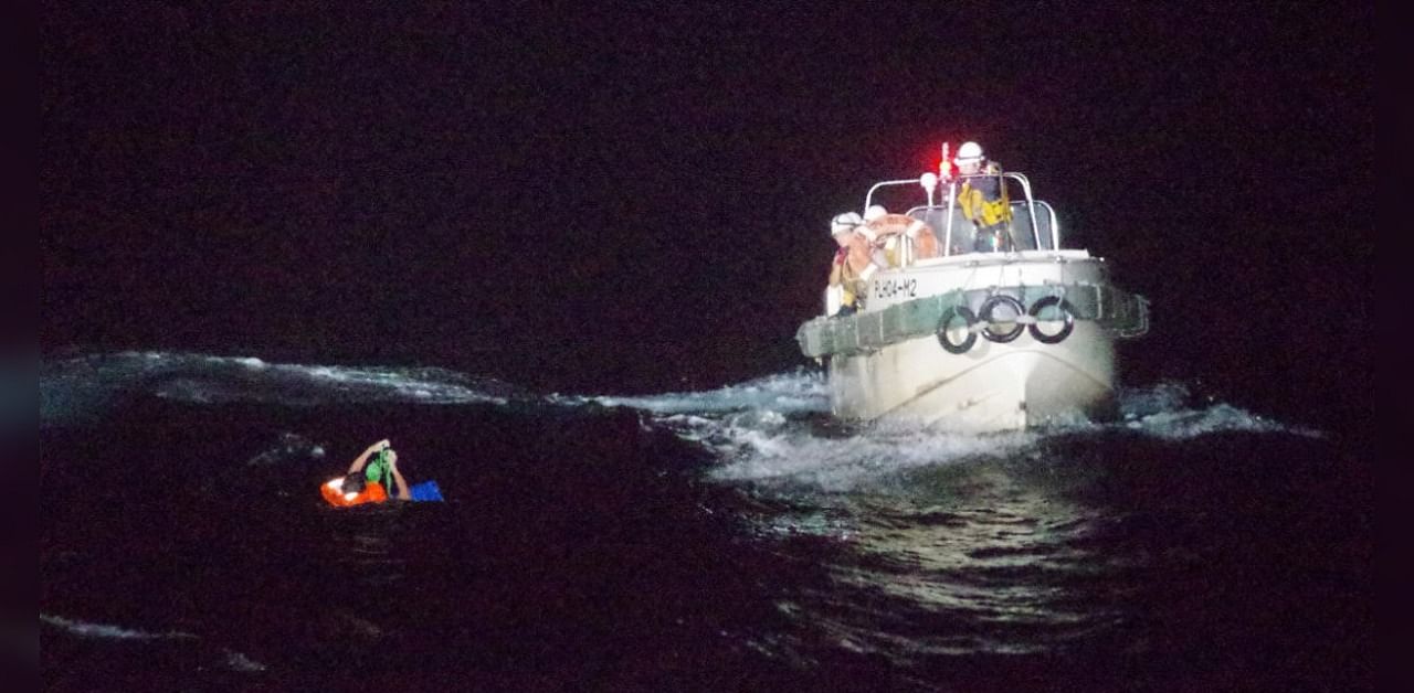 A Filipino crew member is rescued by a Japan Coast Guard boat. Credits: Reuters