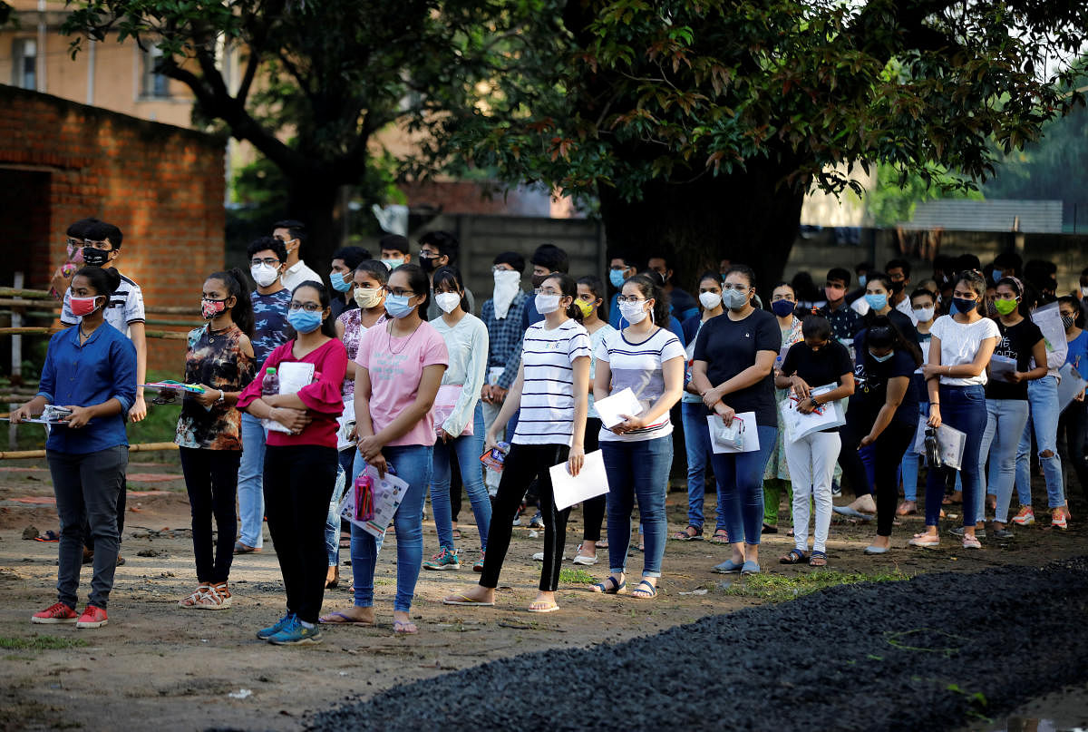 Students wearing protective face masks wait to enter an examination centre for Joint Entrance Examination (JEE), amidst the spread of the coronavirus disease. REUTERS