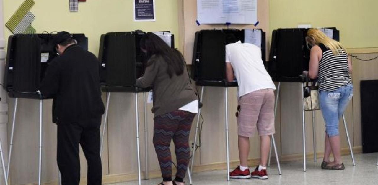 Voters cast ballots in the presidential election at a polling center. Credit: AFP