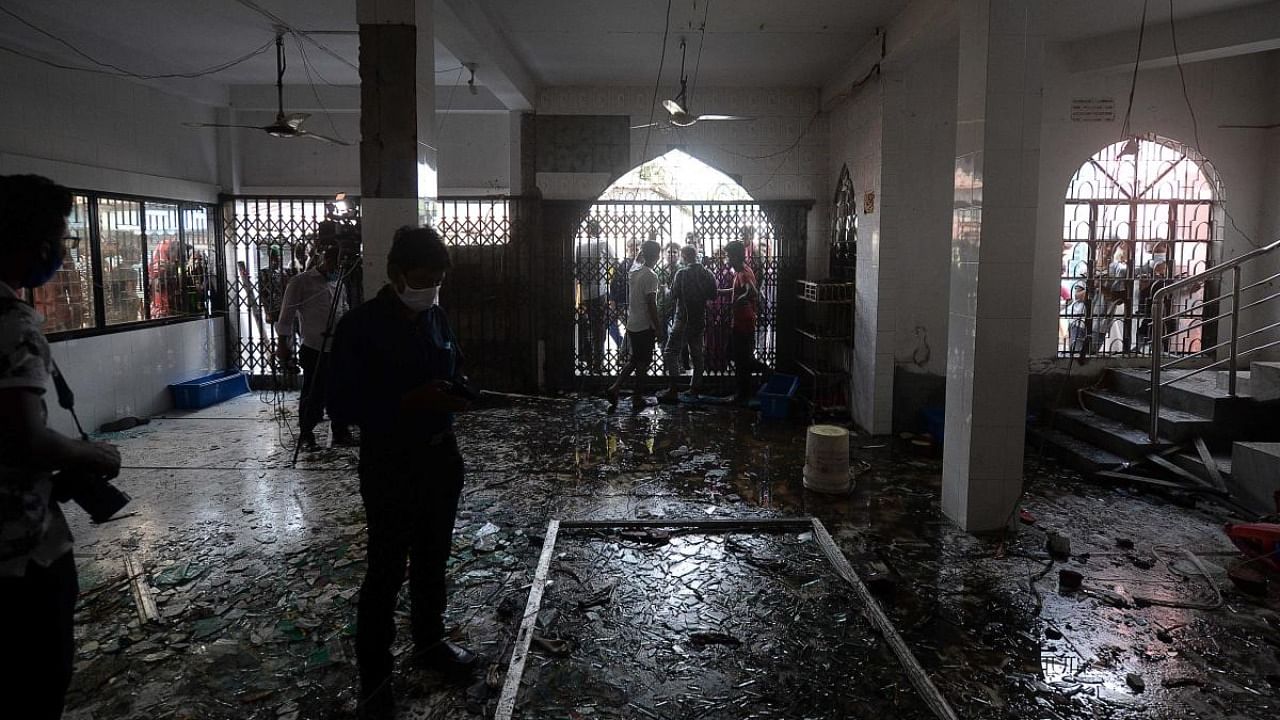 Shattered glasses are seen inside a mosque following a fire in the central district of Narayanganj. Credit: AFP