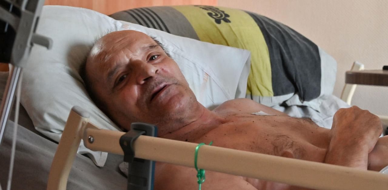Alain Cocq, suffering from an orphan disease called "Ischemia", rests on his medical bed in his flat in Dijon. Credits: AFP