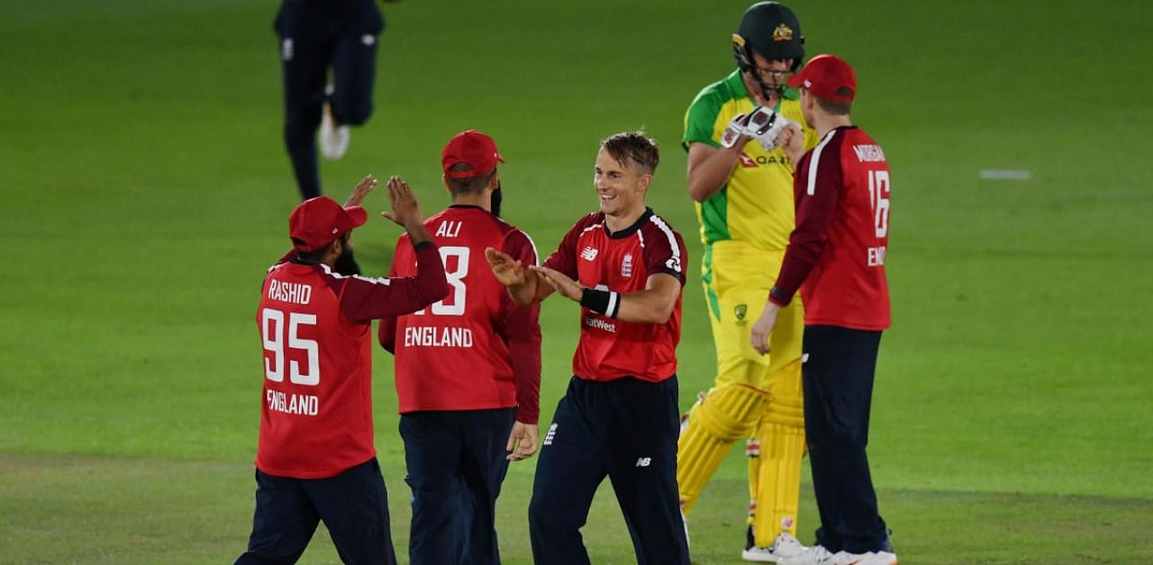 England's Tom Curran and Adil Rashid celebrate victory. Credits: Reuters