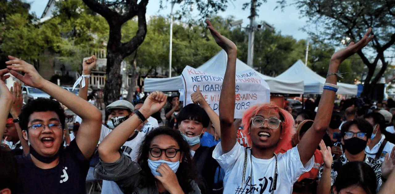 Pro-democracy protesters cheer in support of high school students during a protest for educational reform and against Thailand’s military government in front of the Ministry of Education in Bangkok. Credit: AFP