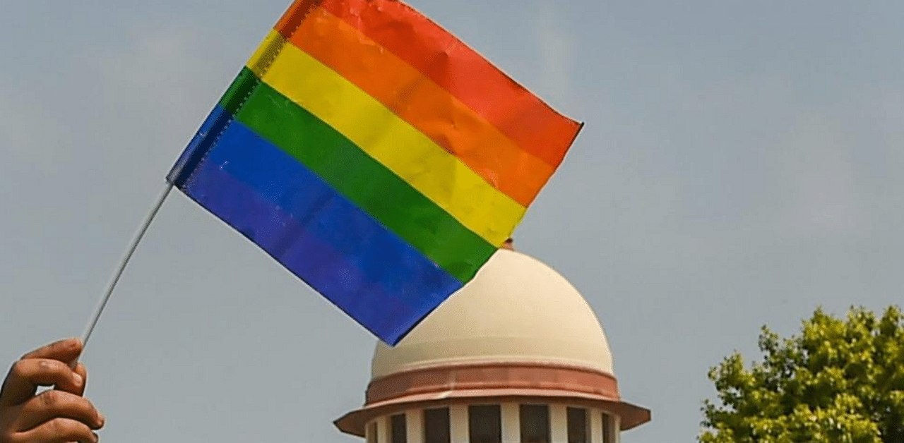 An activist waves a rainbow flag after the Supreme Court verdict which decriminalises consensual gay sex, outside the Supreme Court in New Delhi, Thursday, Sept 6, 2018.  Credit: PTI Photo