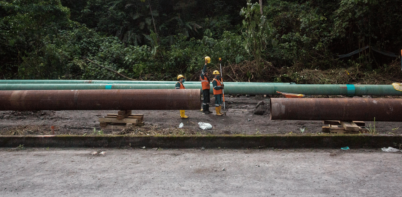 Workers repair a section of oil pipeline about 25 km from the city of Tena in the Amazon. Credit: Reuters Photo