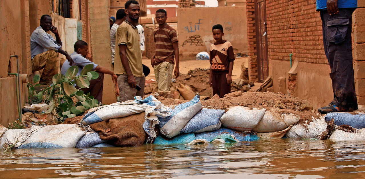 Sudanese stand amidst flood waters in Tuti island. Credit: AFP Photo