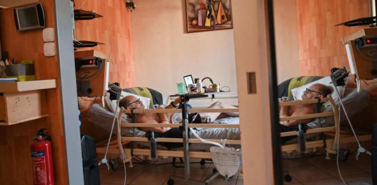 Alain Cocq, suffering from an orphan desease of the blood, rests on his medical bed in his flat in Dijon, northeastern France. Credit: AFP Photo
